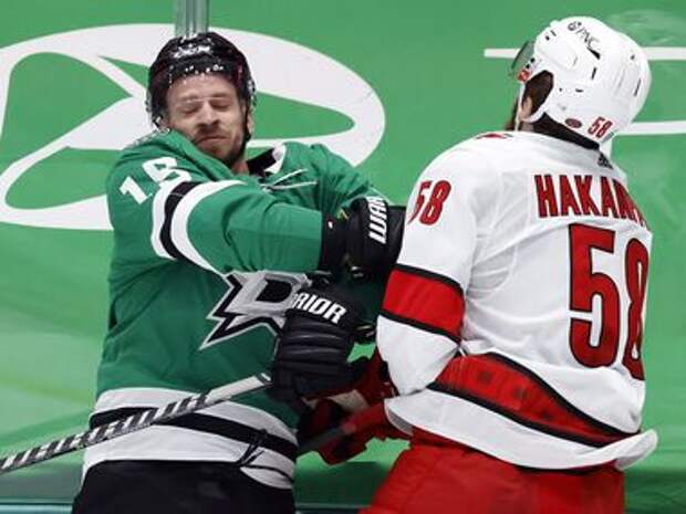 Carolina Hurricanes defenseman Jani Hakanpaa (58) slams Dallas Stars left wing Blake Comeau (15) into the boards during the first period at the American Airlines Center in Dallas, Tuesday, April 27, 2021.