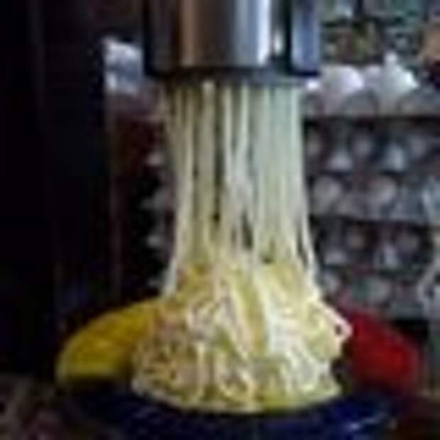 Pressing vanilla ice cream into noodle shape.