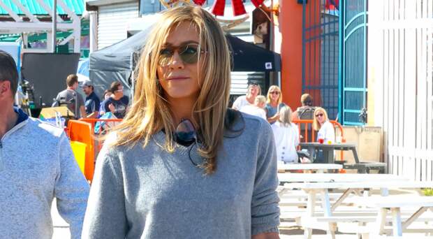 jennifer aniston wearing a sweater on a walk