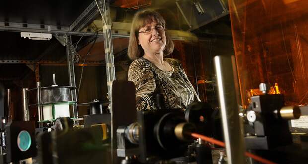 Donna Strickland surrounded by equipment in a laser lab