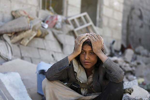 A member of the Houthi group sits on the rubble of houses destroyed by an overnight Saudi-led air strike on a residential area in Yemen's capital Sanaa May 1, 2015. At lease 14 people, including 10 women and a girl were killed and more than 50 injured in the strike that destroyed six houses in Sa'awan residential area, police said. REUTERS/Khaled Abdullah
