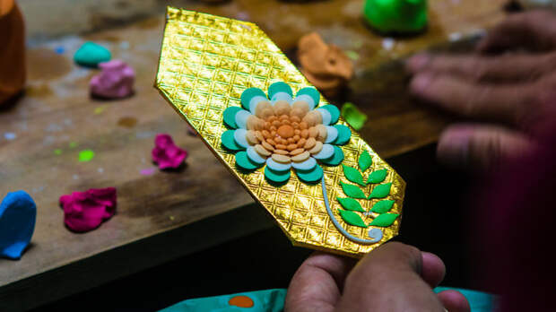 Colored butter is molded onto placards.