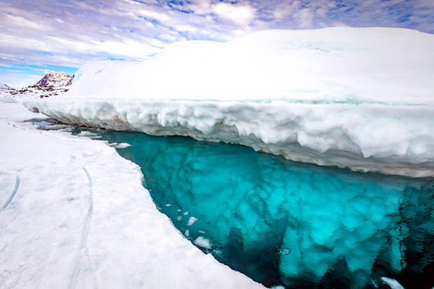 Stunning photos show ice dive beneath giant iceberg