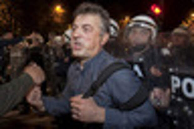 Riot policemen push demonstrators while attempting to disperse them outside the parliament building in the capital Podgorica, Montenegro, October 17, 2015. Montenegro's police used teargas on Saturday to disperse hundreds of anti-government protesters outside the parliament building in the capital Podgorica and local media said several people had suffered light injuries. The ex-Yugoslav republic's main opposition bloc, the Democratic Front, set up tents in front of the parliament 20 days ago demanding the resignation of veteran Prime Minister Milo Djukanovic and the formation of an interim government pending fresh elections.   