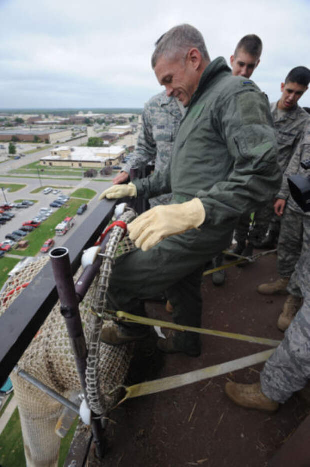 WHITEMAN AIR FORCE BASE, Mo. - Command Chief Master Sergeant Tim Cooley, 509th Bomb Wing, prepares to go down the fire escape from the Whiteman Air Traffic Control Tower, 22 Sept.  Anyone who works in the tower needs to go through this training to ensure they know what to expect in the descent of the extreme drop. (U.S. Air Force Photo by Airman First Carlin Leslie)