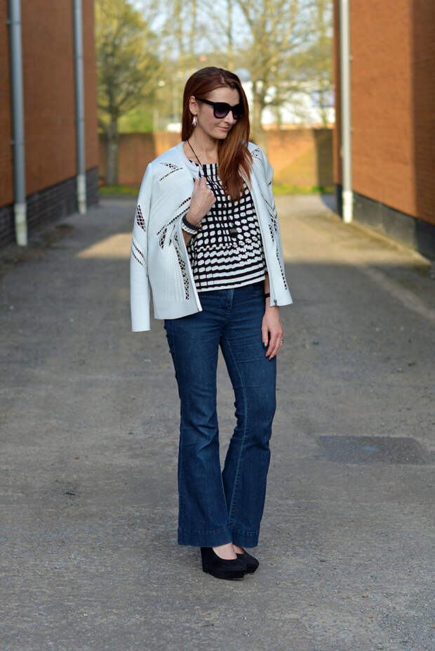 White cut out jacket, black and white boxy top, dark flared denim