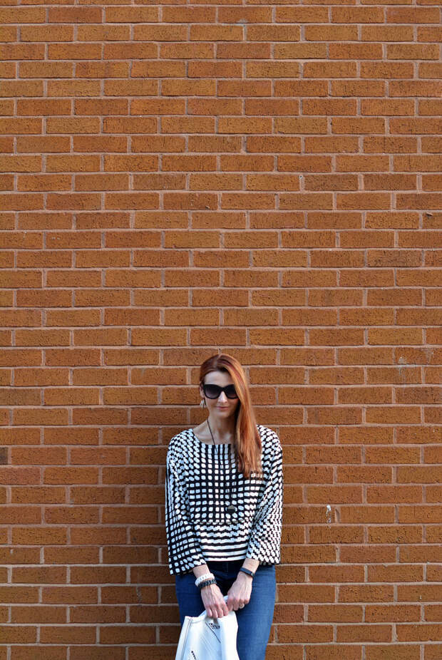 White cut out jacket, black and white graphic boxy top, dark flared denim