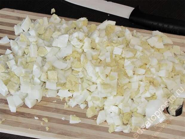 Измельчить отваренные яйца. пошаговое фото этапа приготовления салата с кириешками