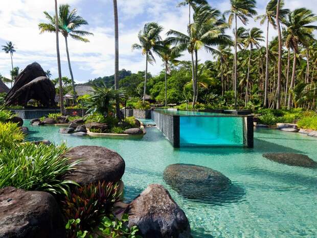 laucala-island-resort-in-fiji-has-an-epic-pool-within-a-pool-with-an-above-ground-glass-lap-pool-embedded-inside-the-larger-more-natural-looking-pool