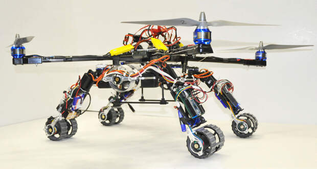 A three-robot hybrid uses two wheeled, bent snakebots and a four-propeller helicopter to travel by land or air, individually or as a team.