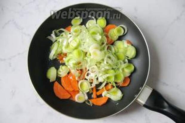 На сковороду выложить нарезанный лук-порей и морковь. Налить подсолнечное масло.