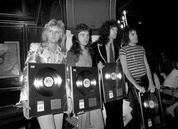 Queen rock band, Roger Taylor, John Deacon, Brian May and Freddie Mercury (left to right), with silver, gold and platinum awards they recieved from the British Phonographic Institute, for the sales of Bohemian Rhapsody and two albums.