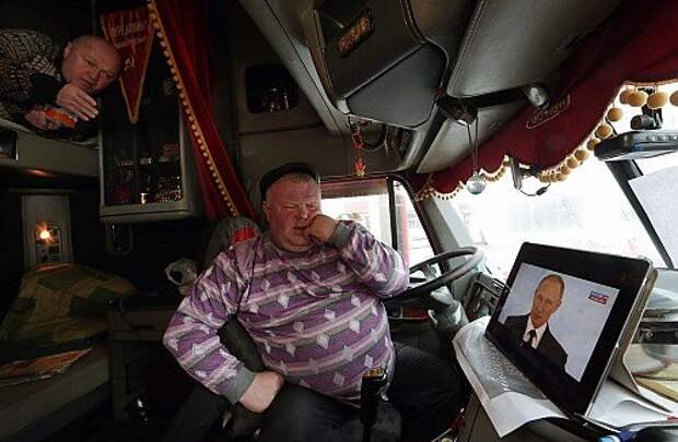Russians watch live broadcast of Russian President Putin's annual address to Federal Assembly