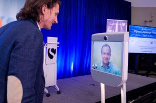 Singularity University CEO Rob Nail speaks with a remote presenter following their Impact Challenge pitch.
