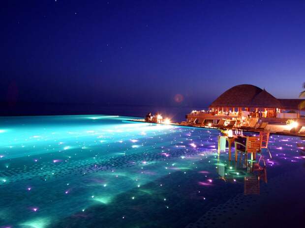 for-a-breathtaking-evening-swim-go-to-the-huvafen-sushi-resort-in-the-maldives-where-the-pool-is-covered-in-colored-lights-that-twinkle-beneath-the-surface
