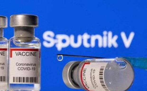 Vials labelled "VACCINE Coronavirus COVID-19" and a syringe are seen in front of a displayed Sputnik V logo in this illustration taken December 11, 2021. REUTERS/Dado Ruvic/Illustration