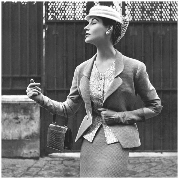 Myrtle Crawford in beige Ottoman suit with fitted jacket indented to v, worn over print cashmere top and narrow skirt by Manguin, hat by Paulette, croc bag by Morabito,1953.jpg Myrtle Crawford in beige Ottoman suit with fitted jacket indented to v, worn over print cashmere top and narrow skirt by Manguin, hat by Paulette, croc bag by Morabito,1953.jpg