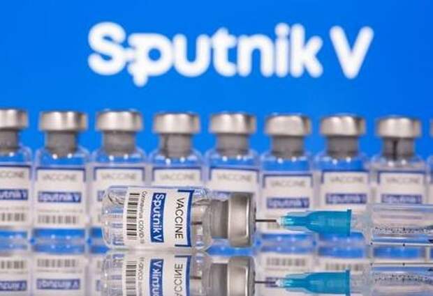 FILE PHOTO: Vials labelled "Sputnik V Coronavirus COVID-19 Vaccine" and a syringe are seen in front of a displayed Sputnik V logo, in this illustration photo taken March 12, 2021. REUTERS/Dado Ruvic/Illustration