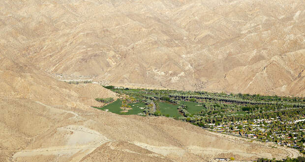 This April 3, 2015, aerial photo shows the Porcupine Creek Golf Club bordering the desert in Rancho Mirage, Calif. California Gov. California cities face mandatory targets to slash water use as much as 35 percent while regulators warn voluntary conservation hasn't been enough in the face of a devastating drought. Underlining their point was data released Tuesday, April 7, showing a new low in saving water. (AP Photo/Chris Carlson)