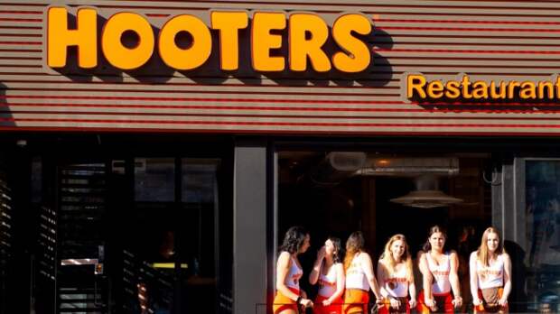 Waitresses on a balcony at a Hooters restaurant.