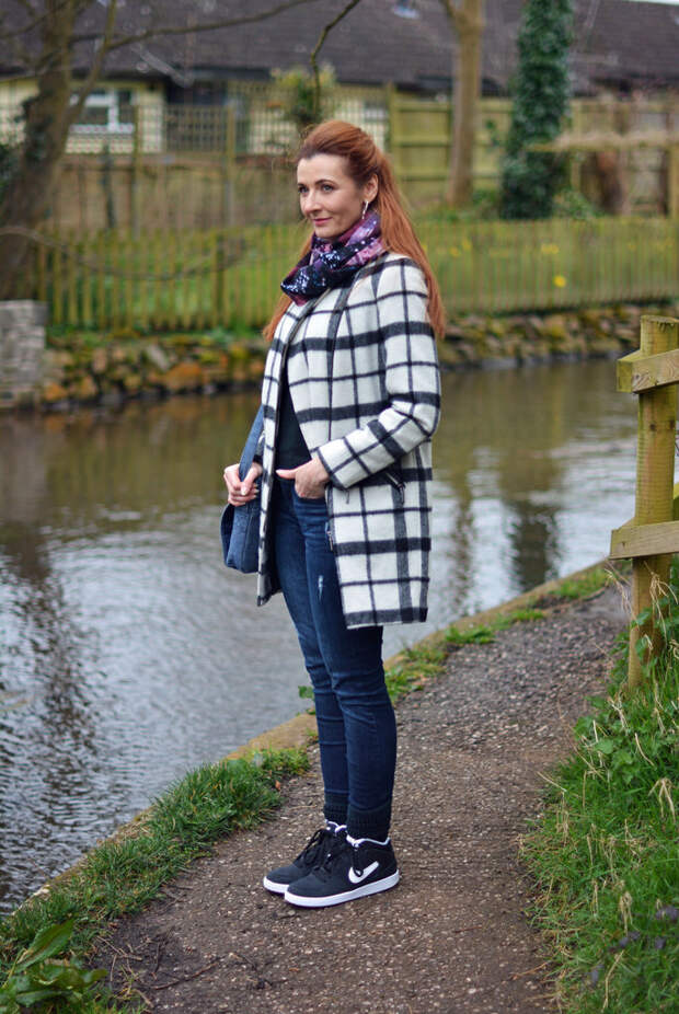 Black and white check coat with denim and Nike hi-tops