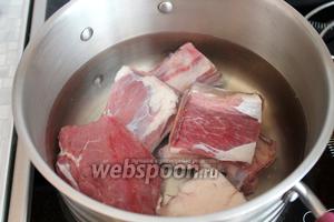Кости и мясо залить холодной водой и довести до кипения.