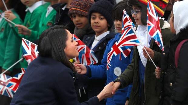 Meghan Markle talks to local school children during a walkabout with Britain's Prince Harry during a visit to Birmingham, Britain, March 8, 2018. 