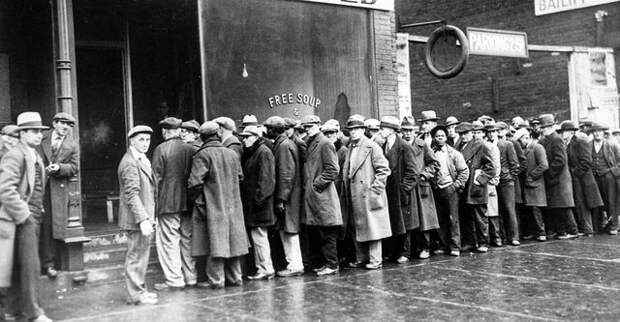 The Great Depression. Unemployed men queued outside a soup kitchen opened in Chicago by Al Capone. The storefront sign reads 'Free Soup, Coffee and Doughnuts for the Unemployed.' Chicago, 1930s (Newscom TagID: evhistorypix027753.jpg) [Photo via Newscom]