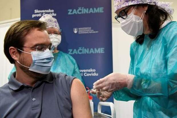 FILE PHOTO: Slovakia's Health Minister Marek Krajci receives an injection with a dose of Pfizer-BioNTech COVID-19 vaccine at the University Hospital, as the coronavirus disease (COVID-19) outbreak continues, in Nitra, Slovakia, December 26, 2020. REUTERS/Radovan Stoklasa/File Photo