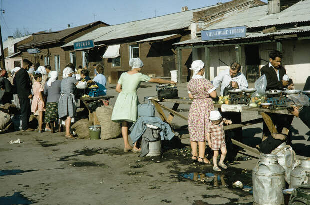 Russia, people at outdoor market. Siberia - Market for privately grown produce in a collective farm village Russia, people at outdoor market. Siberia - Market for privately grown produce in a collective farm village