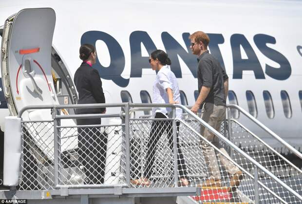 The Duke and Duchess of Sussex are pictured boarding a Qantas Boeing 737 aircraft at Queensland's Hervey Bay Airport