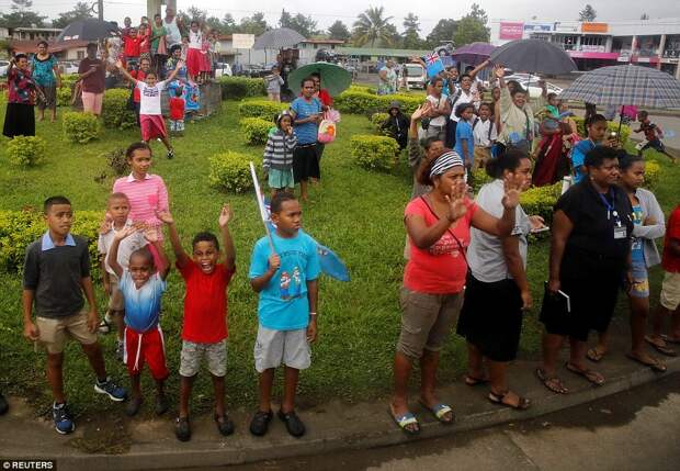 Well-wishers stood in the rain along the streets and waved as Prince Harry and Meghan arrived in Suva, Fiji