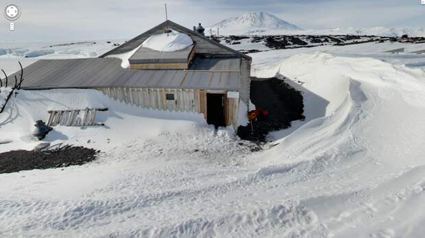 an-outside-view-of-scotts-hut-the-mountain-in-the-background-is-mount-erebus-the-highest-volcano-in-antarctica
