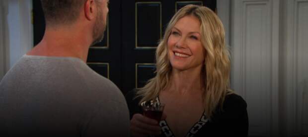 Kristen holding a drink and smiling at EJ on Days of Our Lives during the week of 2-17-25