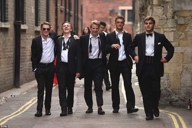 Men in black: A group of smartly-dressed friends make their way back to their student halls after partying all night