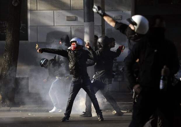 Protestors attack a police vehicle durin