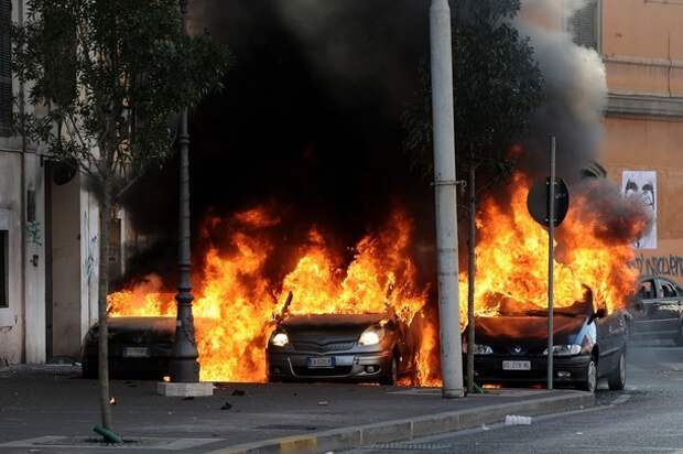 Cars burn during a demonstration, in dow