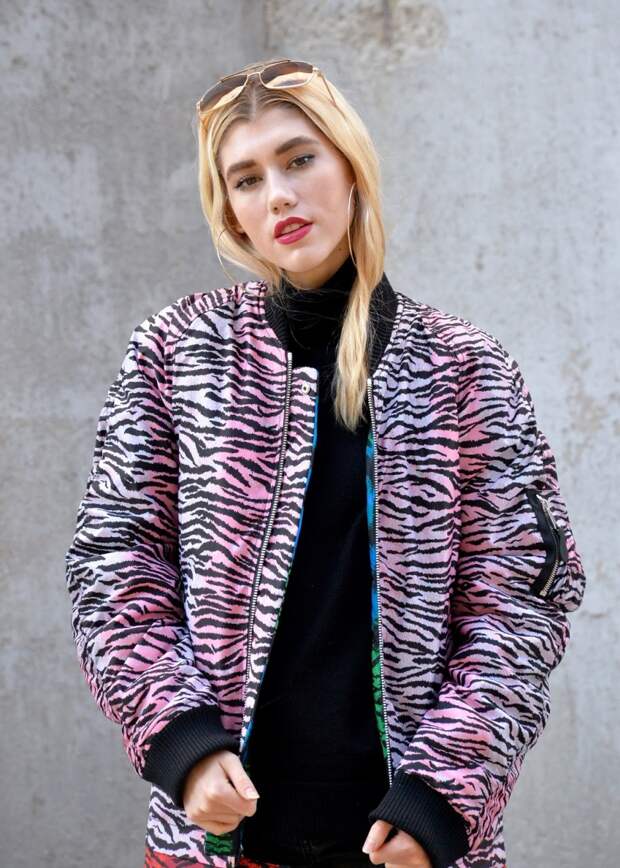 Girl wearing sunglasses and gold hoop earring with a zebra print coat by KENZO X H&M