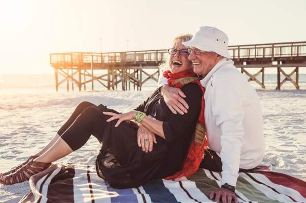 Senior couple embracing on the beach.