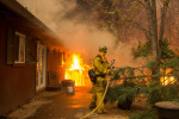 A CalFire firefighter attempts to cool down the side of a home in the Paradise Pines neighborhood of Magalia as the Camp Fire continues to burn out of control through the region, fueled by high winds in Butte County, California, USA, 09 November 2018. The nearby communities of Pulga, Paradise and Concow, have been ordered to evacuate the area. Butte County wildfire and evacuations, USA - 08 Nov 2018