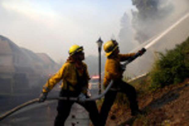 Firefighters battle an advancing wildfire in a residential subdivision, in Westlake Village, Calif California Wildfires, Westlake Village, USA - 09 Nov 2018