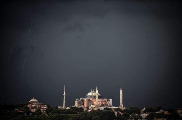 Clouds gather over the Hagia Sophia museum during a storm on August 7, 2014.
