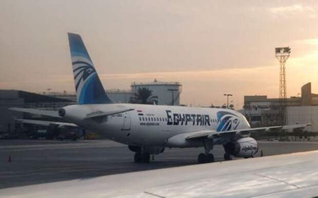 An EgyptAir A320 plane is pictured through the window of an Etihad Airways plane after it landed on the runway at Cairo International Airport, Egypt December 16, 2017. Picture taken December 16, 2017. REUTERS/Amr Abdallah Dalsh