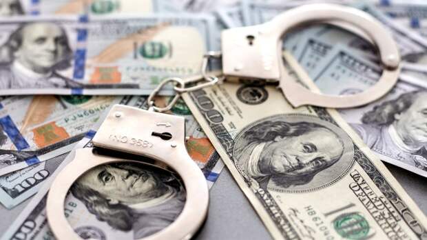 Handcuffs Laying on One Hundred Dollar Bills