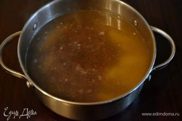 Бульон довести до кипения. Выложить картофель. Через 5–7 минут добавить отварную фасоль. Затем выложить пассерованные овощи с томатной пастой. Огонь уменьшить до минимального и потомить суп еще минут 20–25. Посолить.