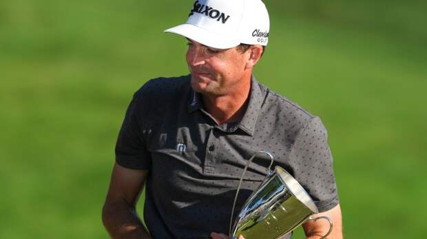 Keegan Bradley holding Travelers Championship trophy