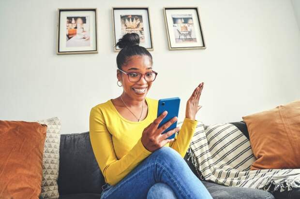 Happy person looking at phone in hand.