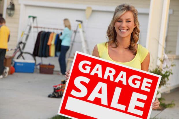 woman-having-garage-sale-holding-sign_liqjeq
