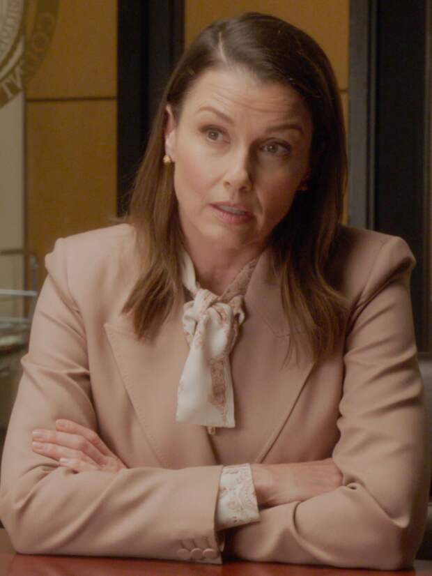 Erin sits with a defendant in her office on Blue Bloods Season 14 Episode 16.
