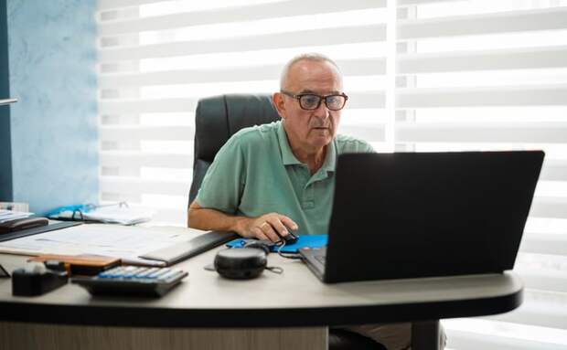 A person with a serious expression at a laptop.